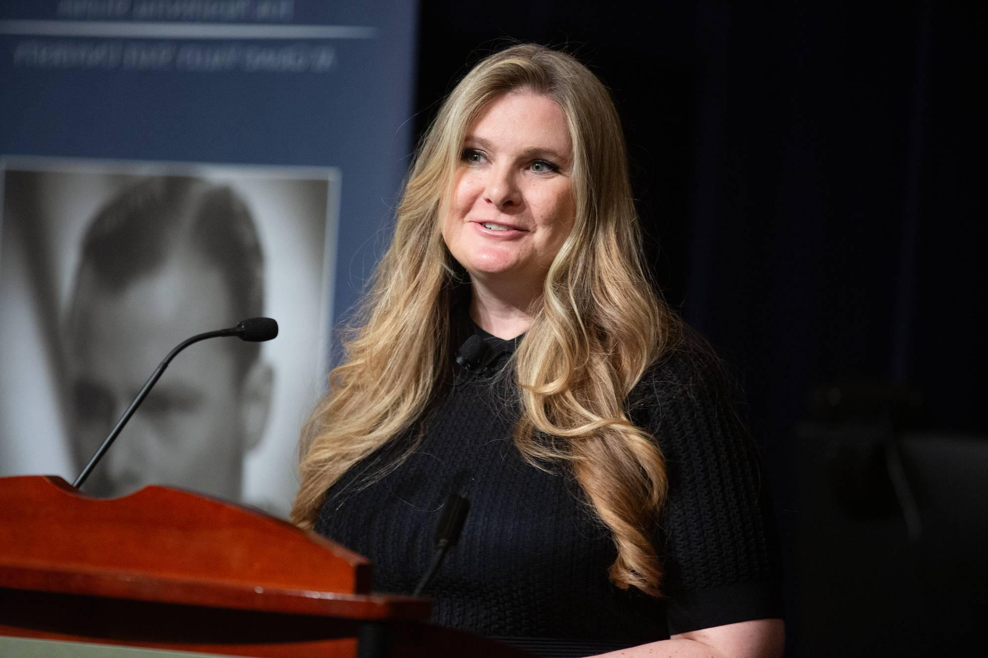 person speaking at a podium